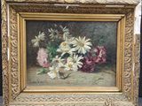 an oil painting of flowers in a gold frame on a table