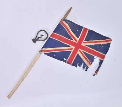 a small british flag on a stick and a key