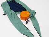 a bag that is sitting on the ground next to an orange container
