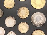 a lot of coins that are on a black surface