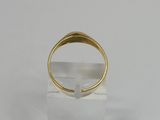 a close up of a gold ring on a clear stand