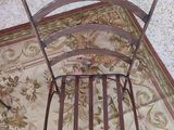 a chair that is sitting on a rug on the floor