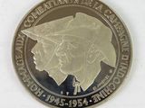 a silver coin with a picture of a man and a woman on it