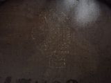 a close up of a wooden barrel with a logo on it
