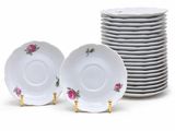 white plates with pink roses on them are stacked on top of each other