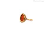 an image of a gold ring with a red stone in it