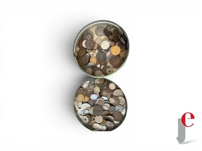 two tins filled with coins sitting on top of a white surface