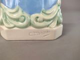 a ceramic vase with a blue and green design on it