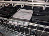 many bottles of wine in a dishwasher with a sign on it