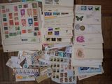 many different types of stamps and envelopes laid out on the floor
