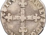 a close up of a coin with a cross on it