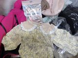 a pile of clothes that is sitting on the floor