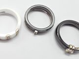 three different rings are shown on a white surface