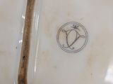 a white plate with a wooden handle on it