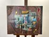 a picture of a painting on a easel with a lot of pictures on it
