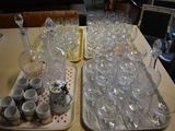 two trays of empty wine glasses on the table