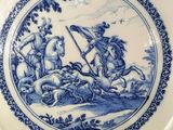 an image of a blue and white plate with a picture of a man on a horse