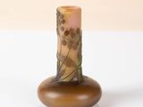 a small vase with a design on it on a white surface