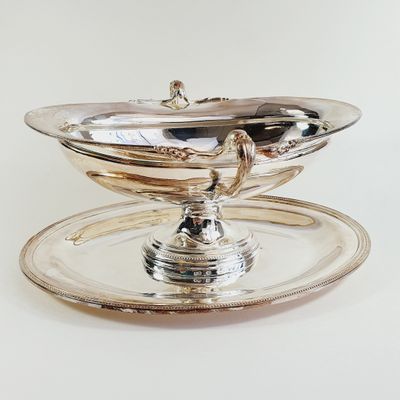 a silver plate with a bowl on top of it