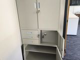 a cabinet with a door open in the corner of a room