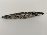 a close up of a metal object on a white surface