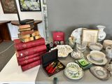 a table that has a lot of books and bowls on it