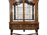 an old wooden china cabinet with glass doors and drawers