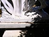 a statue of a woman sitting on top of a bench
