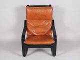 a brown leather chair with black legs and a black frame