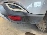 a close up of the rear end of a car with mud on the ground