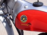 a close up of a red motorcycle parked on the street