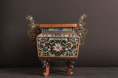 a small wooden cabinet with a floral design on it