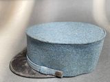 a blue hat sitting on top of a coin on a table