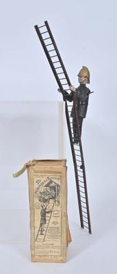 a figurine of a man standing on a ladder next to a book