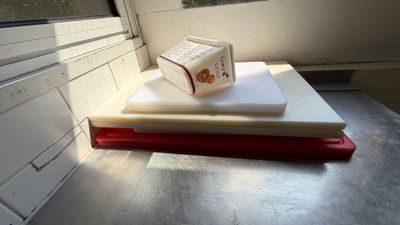 a stack of books sitting on top of a table next to a window