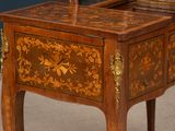 a small wooden table with a mirror on top of it