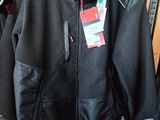 two jackets hanging on a rack in a store