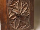 carvings on the back of a wooden box on a white surface