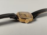 an image of a close up of a wrist watch on a white surface