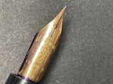 a close up of a fountain pen on a table
