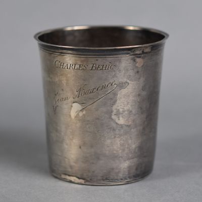 a silver cup that is sitting on a table
