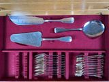 a wooden box with silverware in it on a table