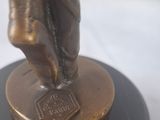 bronze statue of a man holding a baseball bat on a black base