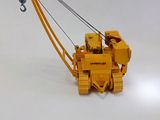 a toy crane that is sitting on a white surface