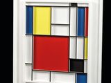 a white frame with a painting of a red, yellow, blue and black square