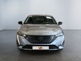 the front view of a silver car in a showroom
