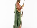 a figurine of jesus holding a staff and wearing a green robe