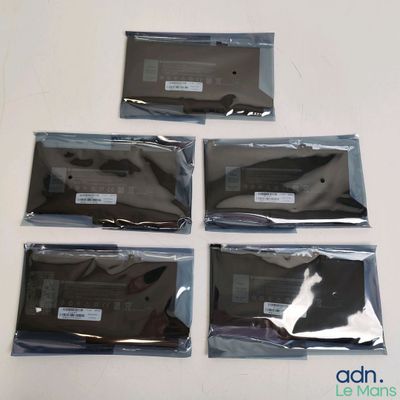 six pieces of black plastic bags sitting on top of a white table