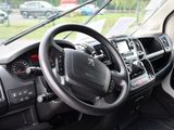 a steering wheel and dashboard of a truck in a parking lot