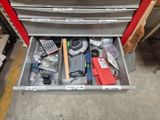 a drawer full of tools in a garage